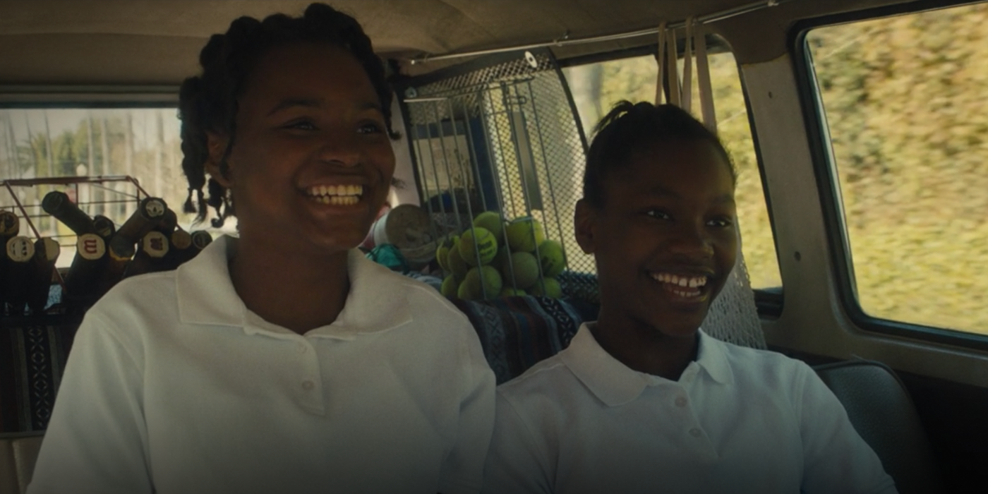 Venus and Serena Williams smile in the back of a car in King Richard