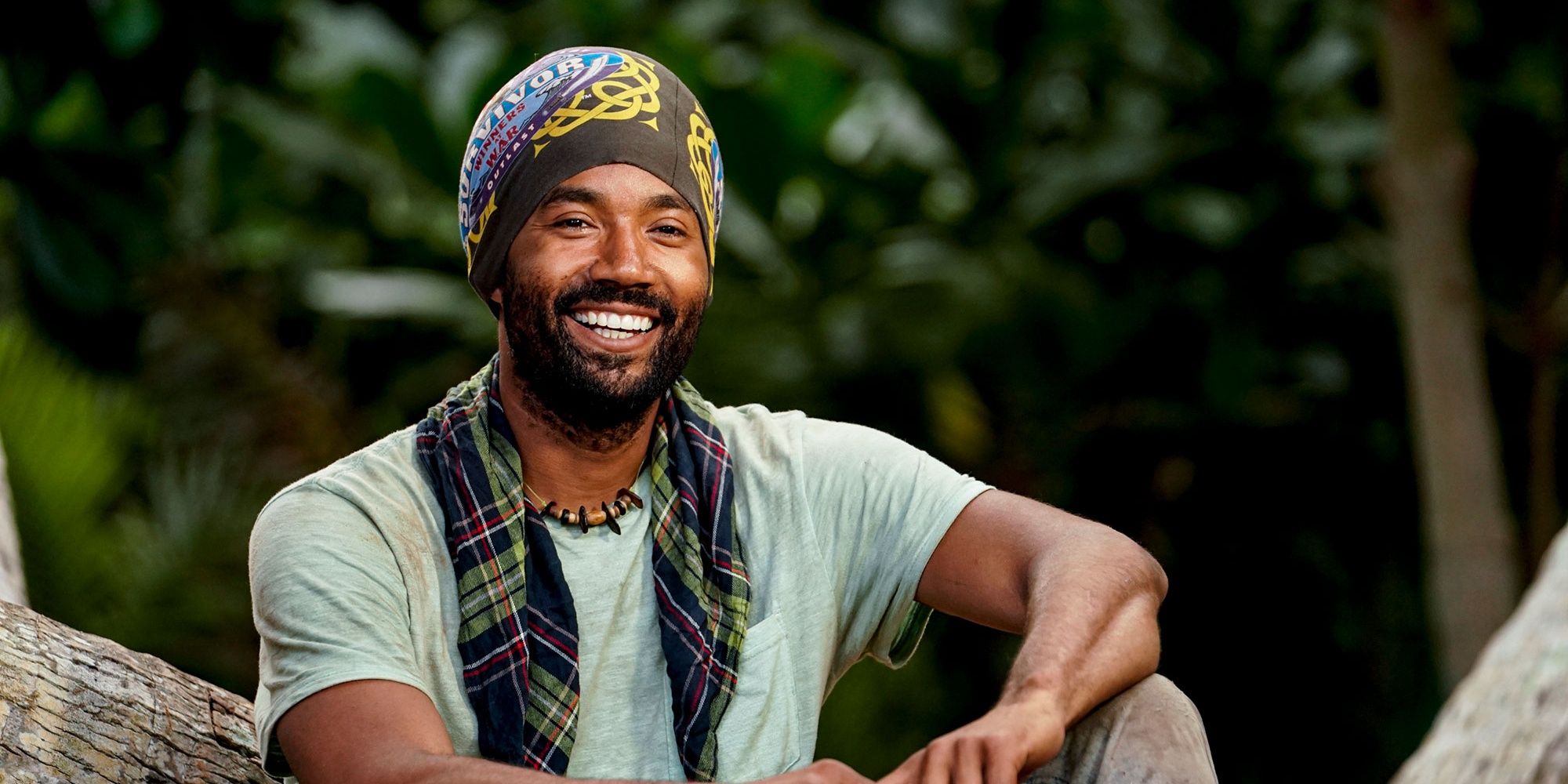 Wendell from Survivor sitting on a tree