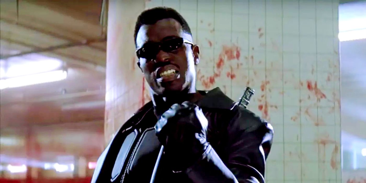 Blade raising a fist and smiling in a bloody factory in Blade.