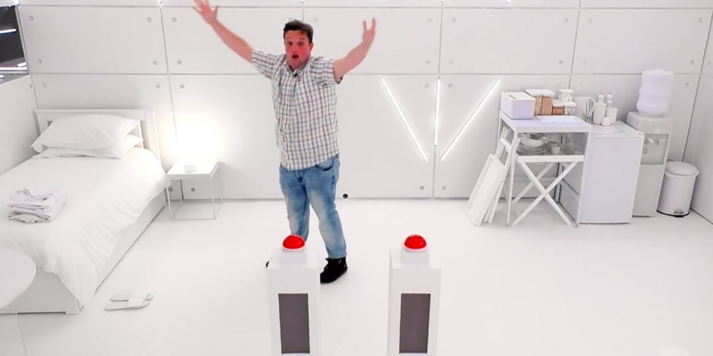 A Big Brother contestant raising their arms in the white room