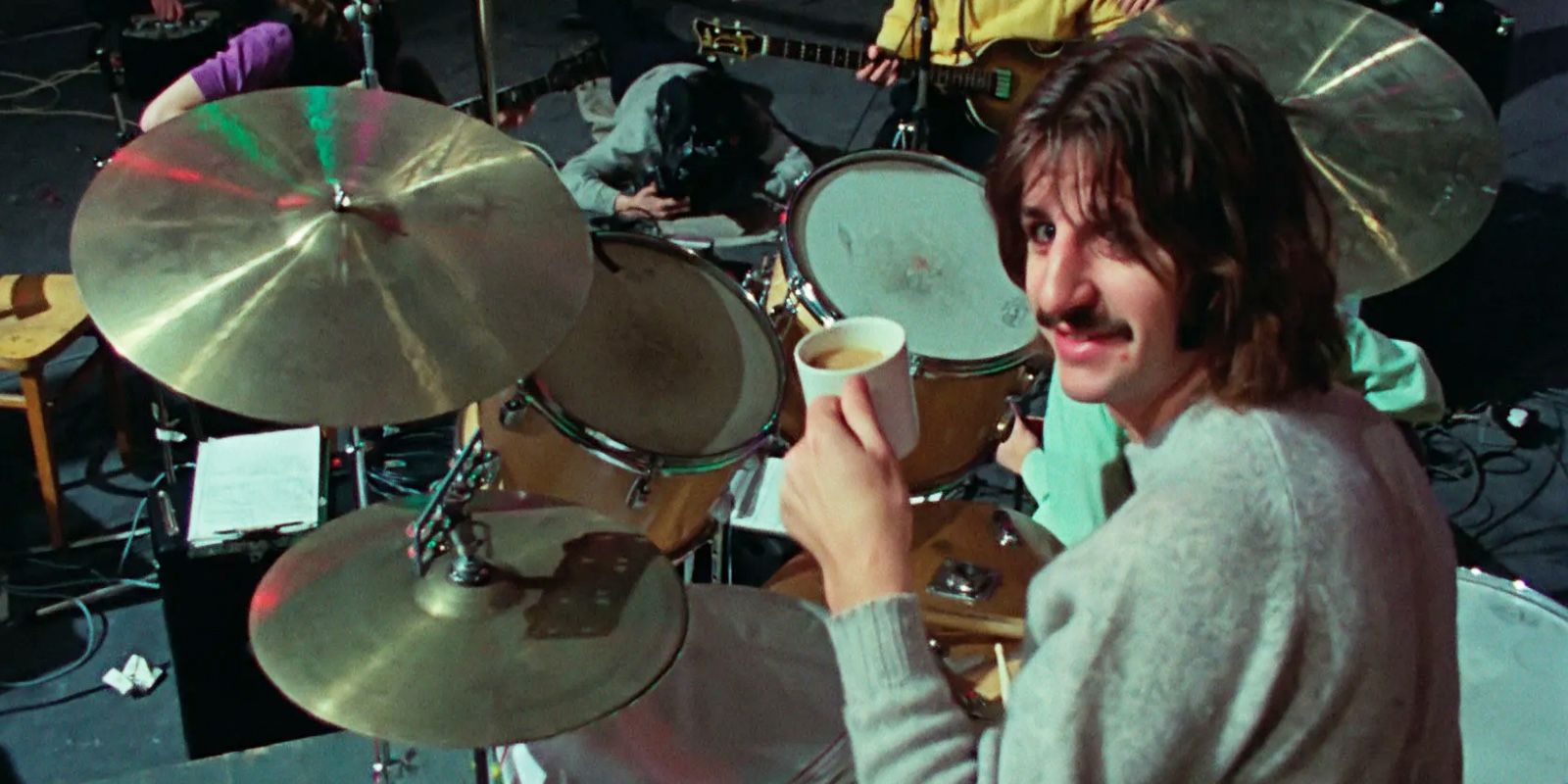 Ringo has a coffee while at a drum set in The Beatles: Get Back.