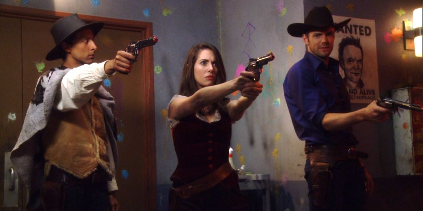 Abed, Annie, and Jeff dressed as Western characters brandishing guns