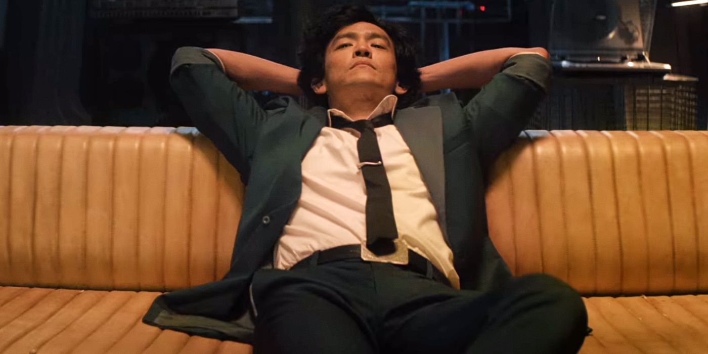 John Cho relaxes on a couch in Netflix's Cowboy Bebop.