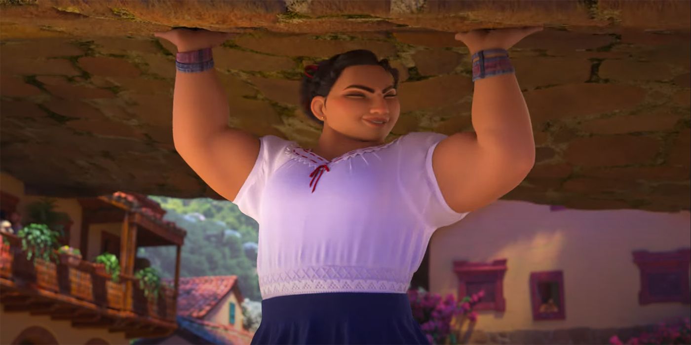 Luisa holds a rock over her head in Disney's Encanto.