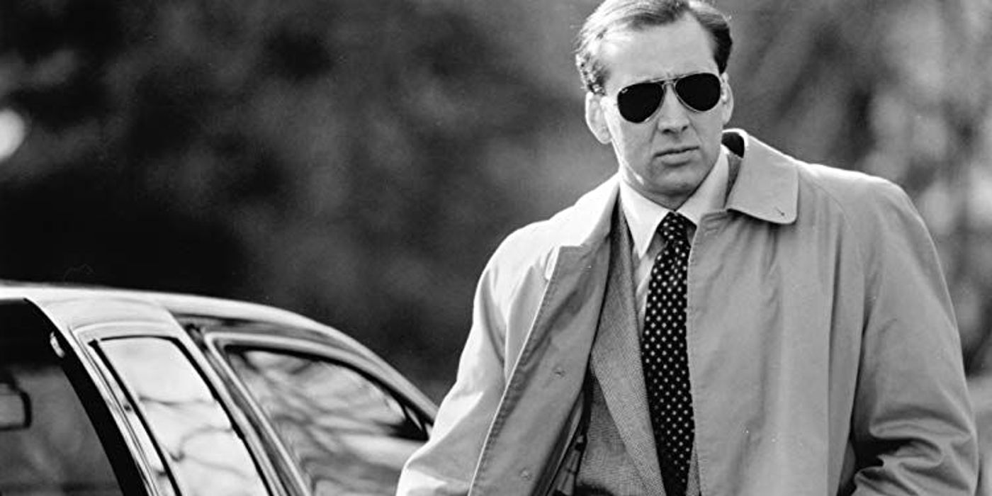 Nic Cage in black and white in a coat and sunglasses for Guarding Tess