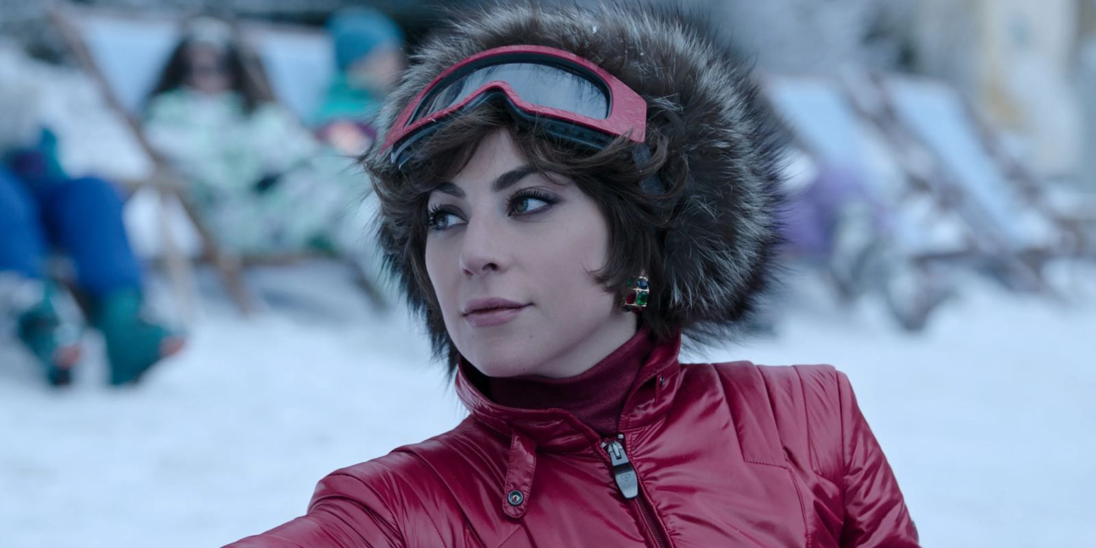 Patrizia Reggiani wears a ski outfit and looks to her side in House of Gucci.