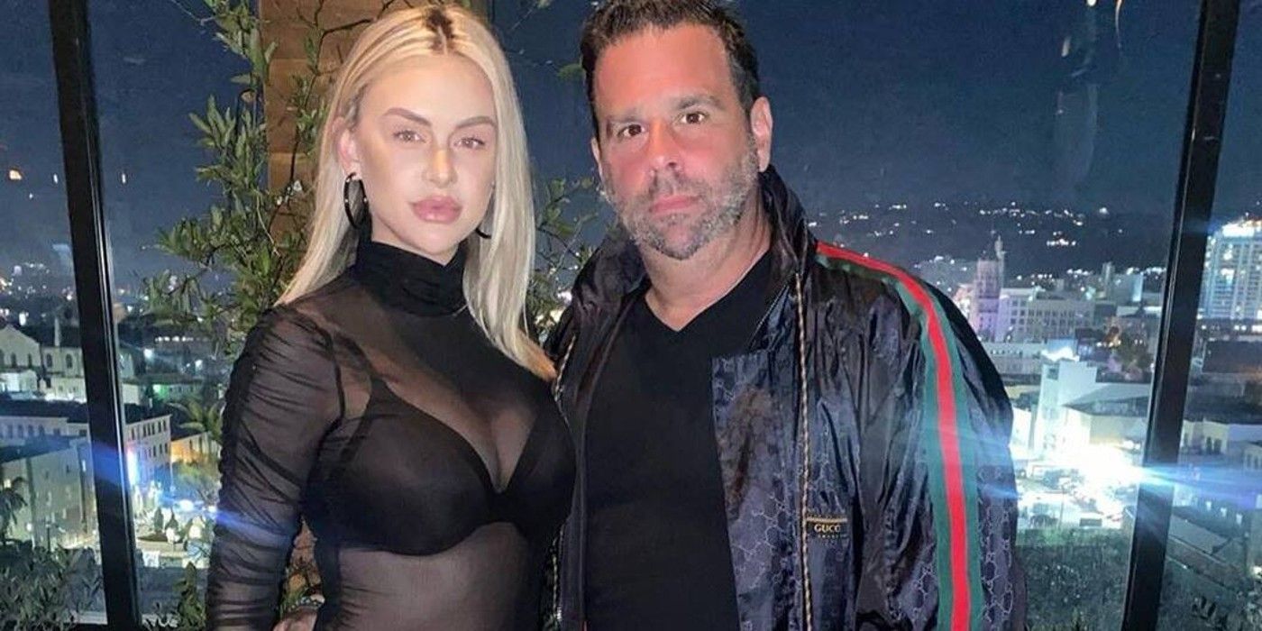 Vanderpump Rules' Lala Kent and Randall Emmett posing in front of a city skyline