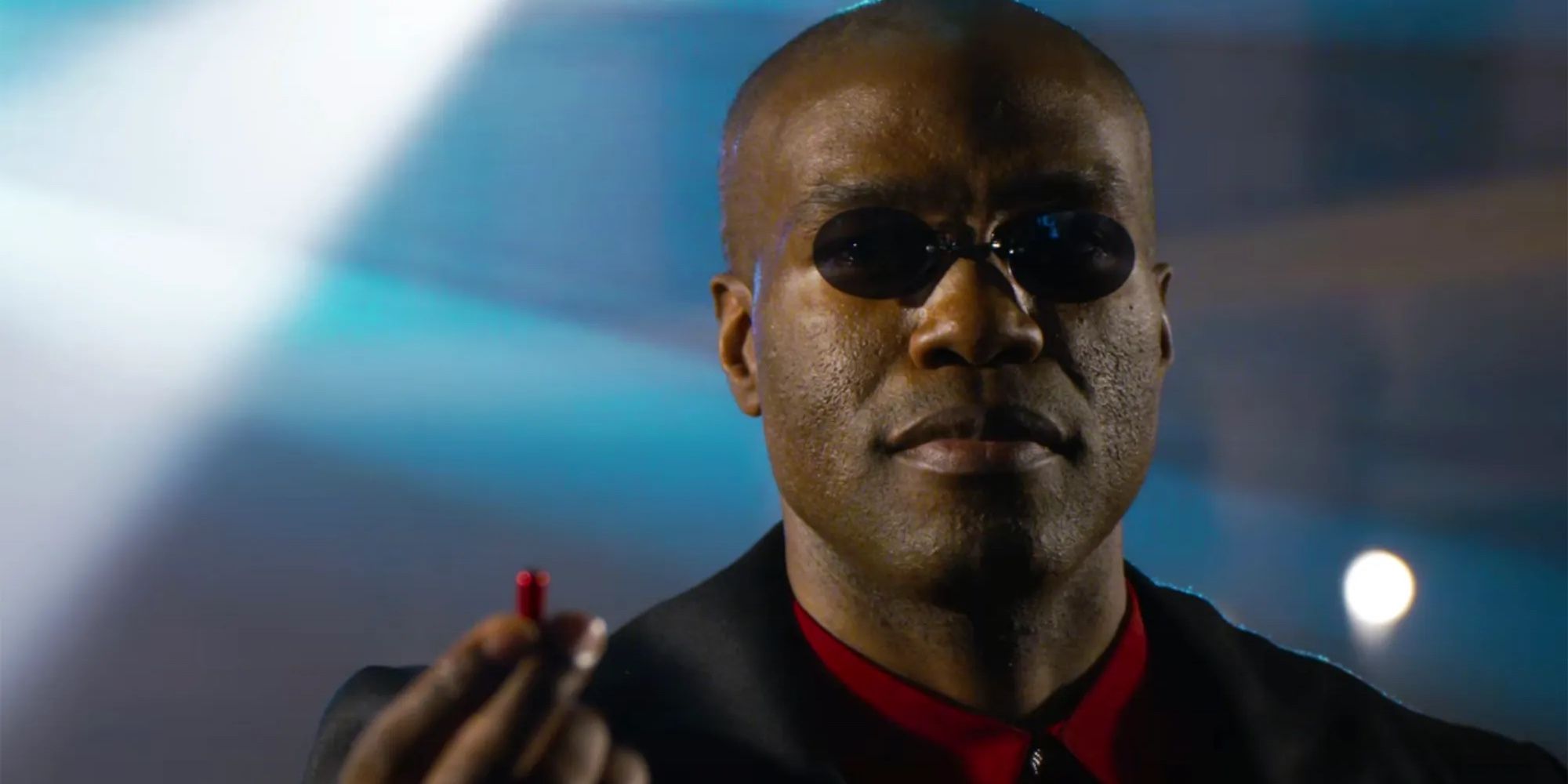 Morpheus holds up a red pill in The Matrix Resurrections