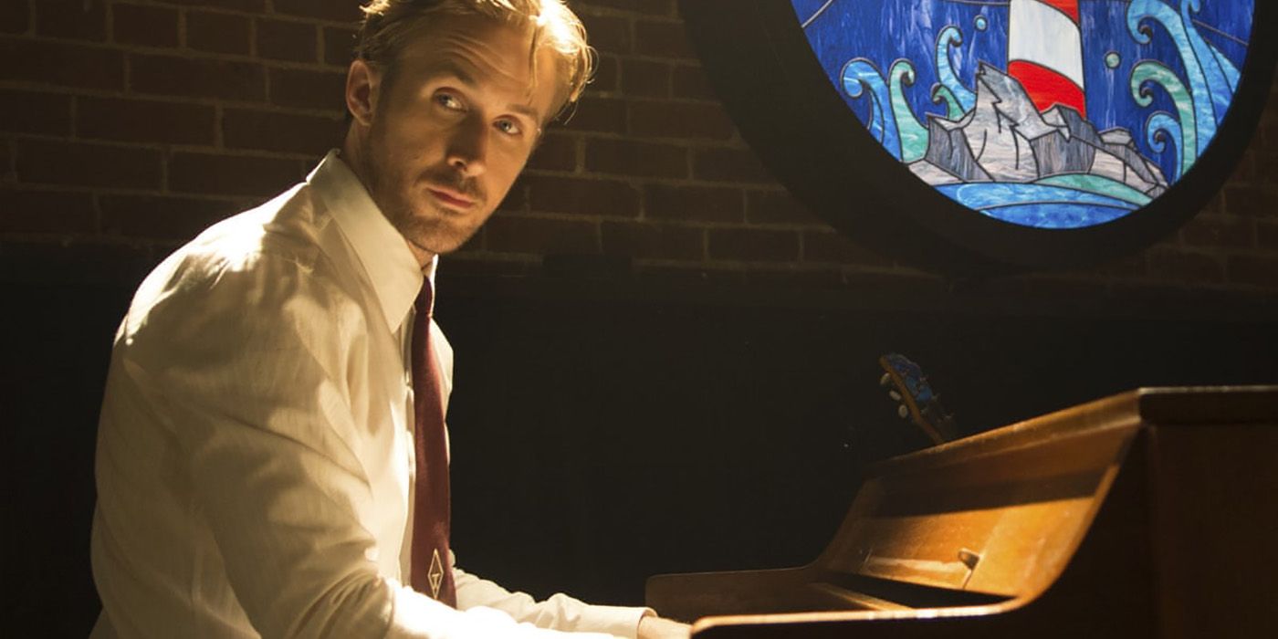 Ryan Gosling sitting at a piano, looking to the side at someone in a scene from La La Land.