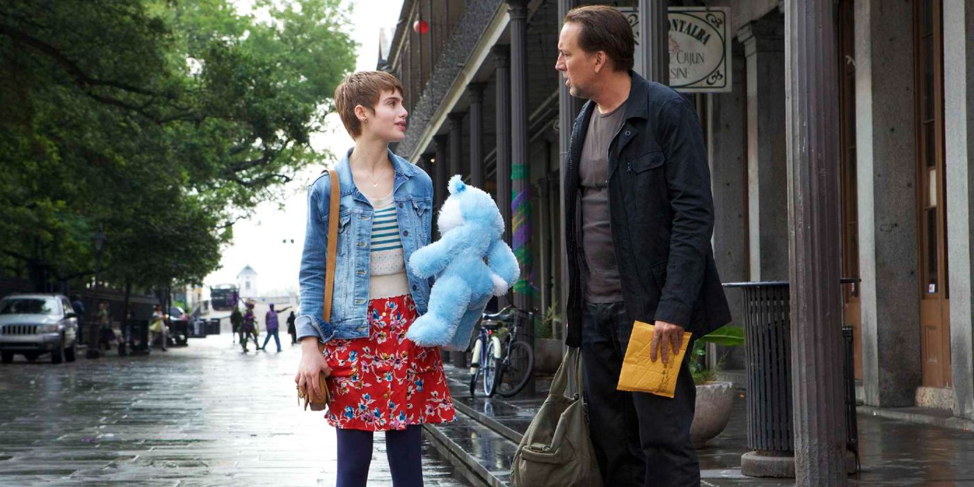 Nick Cage talks to a girl holding a stuffed bear in Stolen.