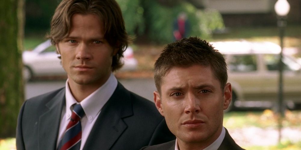 Sam and Dean stand together outside on Supernatural