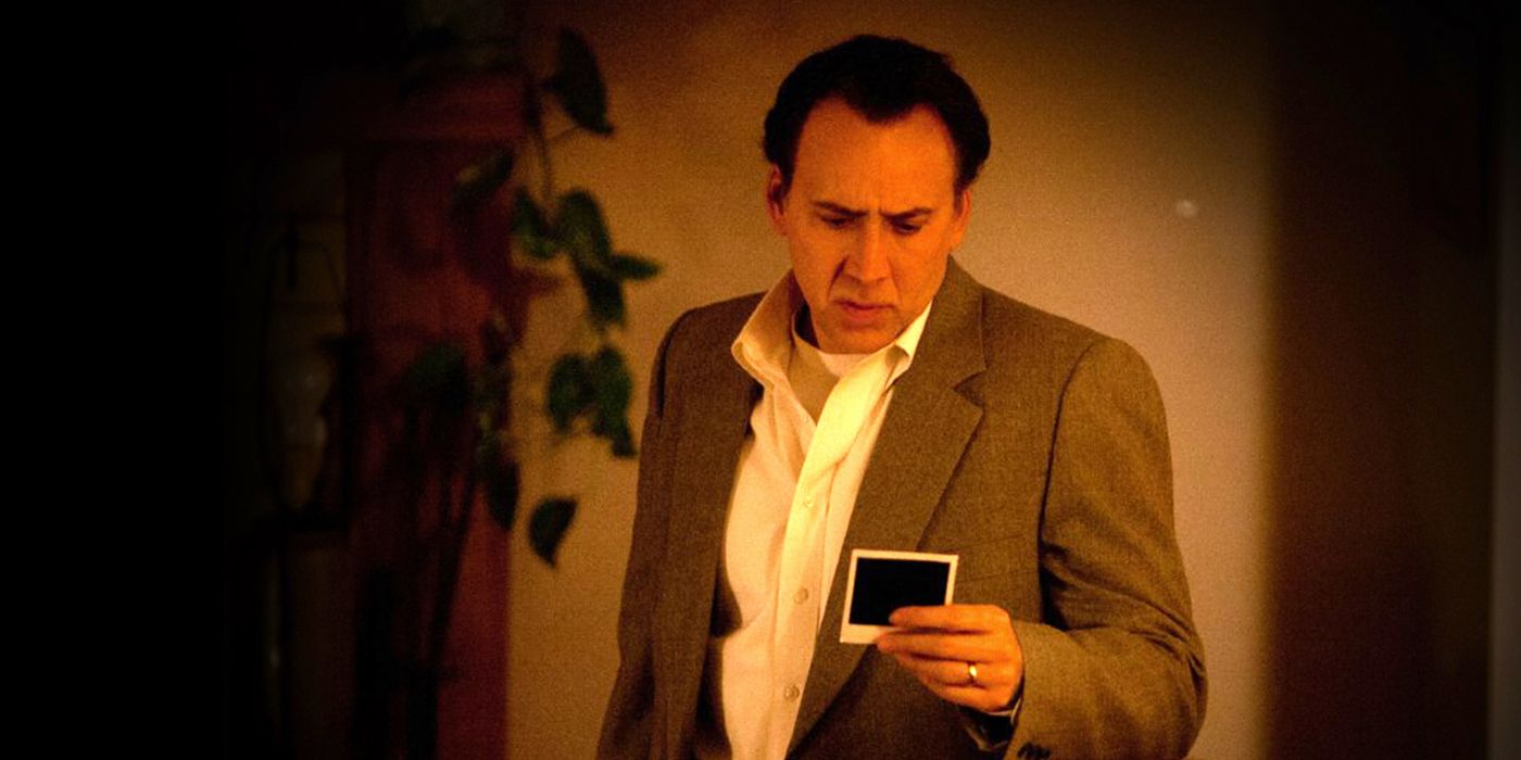 Nicolas Cage looking at a photograph in The Frozen Ground
