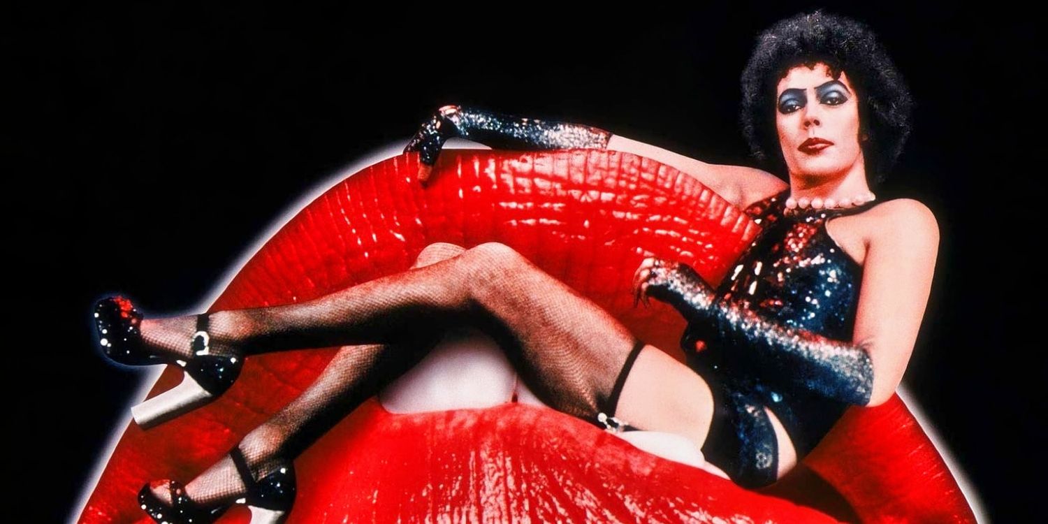 Tim Curry in full costume as Frank, sitting on the lips of the Rocky Horror Picture Show