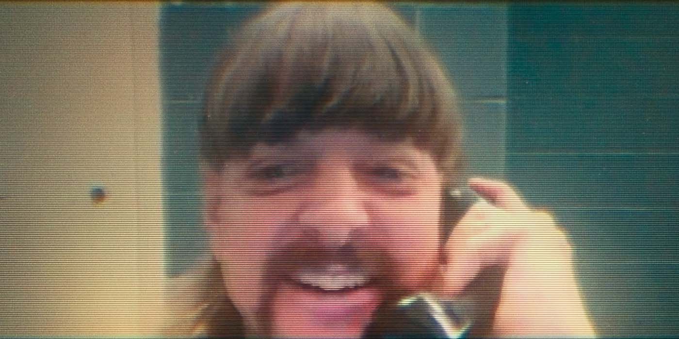 Joe Exotic smiling, on the phone while in jail in a scene from Tiger King 2.