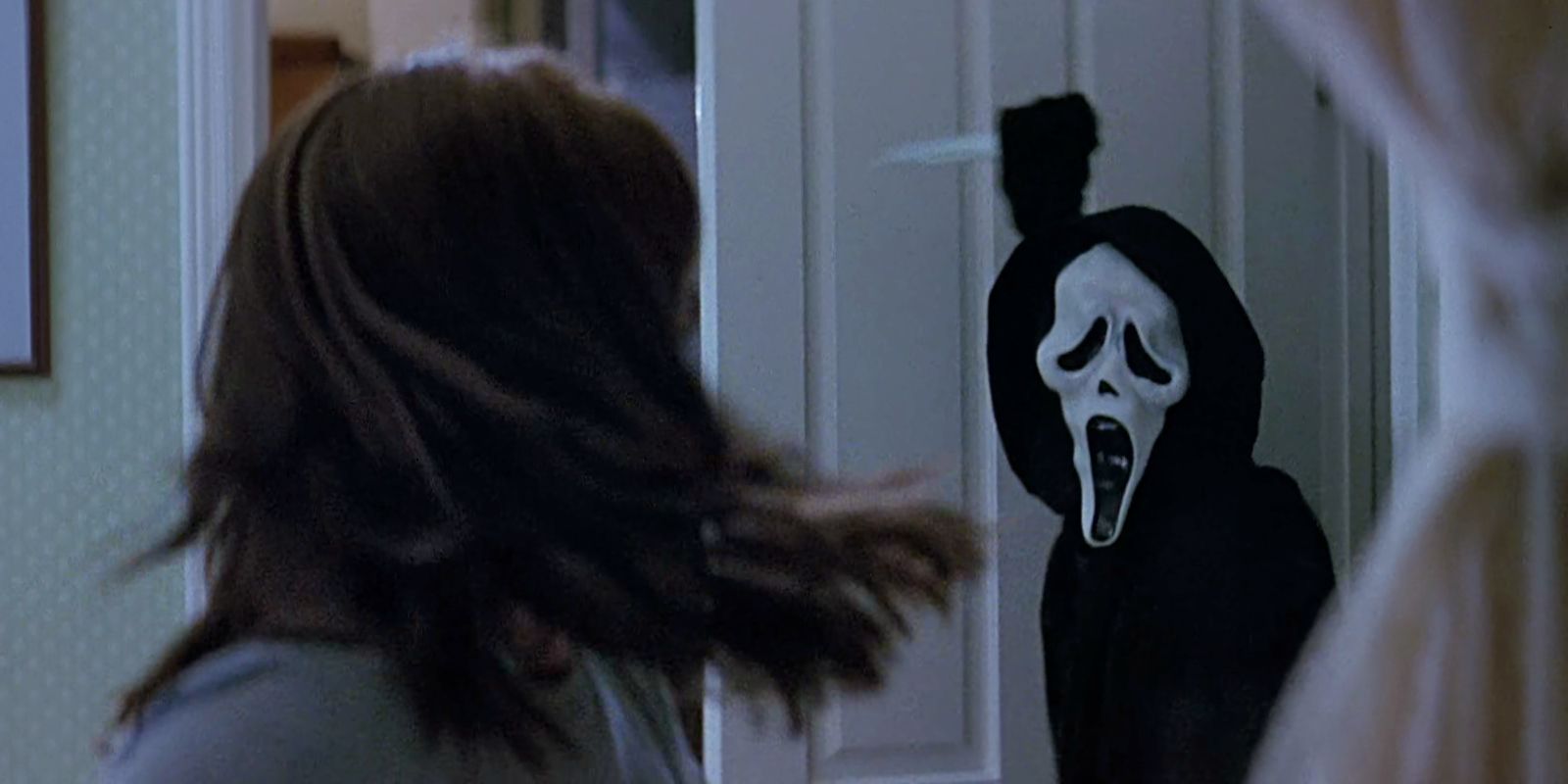Sydney turns around and sees Ghostface with a knife in Scream.