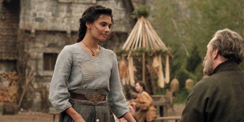Egwene smiling at Tam al'Thor in Emond's Field in The Wheel of Time.