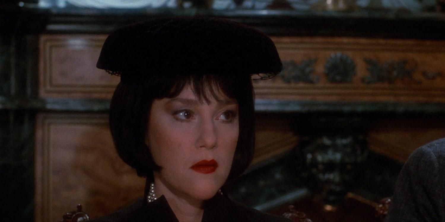 A closeup of Mrs White wearing a hat in Clue