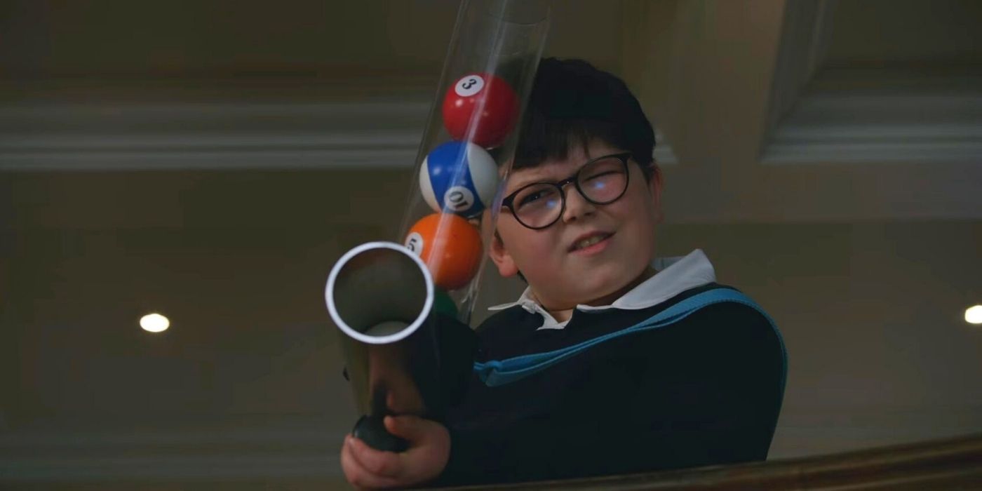 A little boy from Home Sweet Home Alone aiming a fake gun at intruders