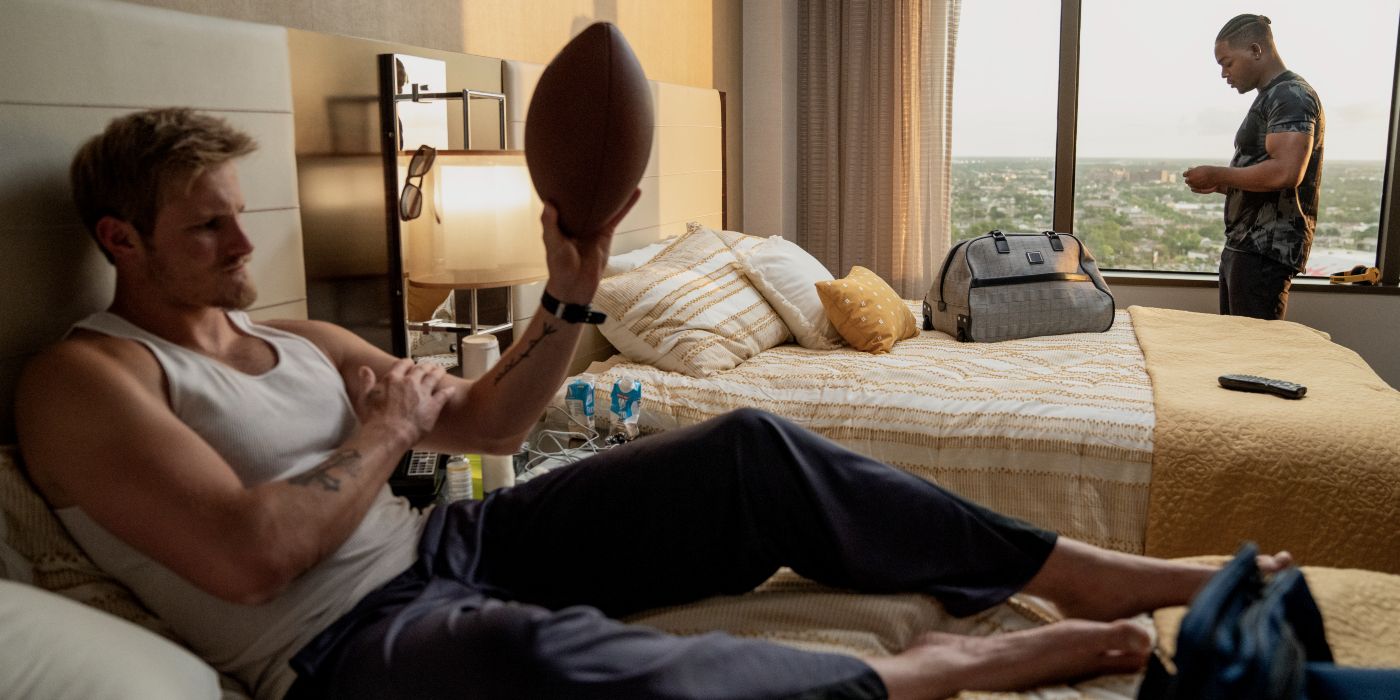 Emmett plays with a football in his hotel room in National Champions