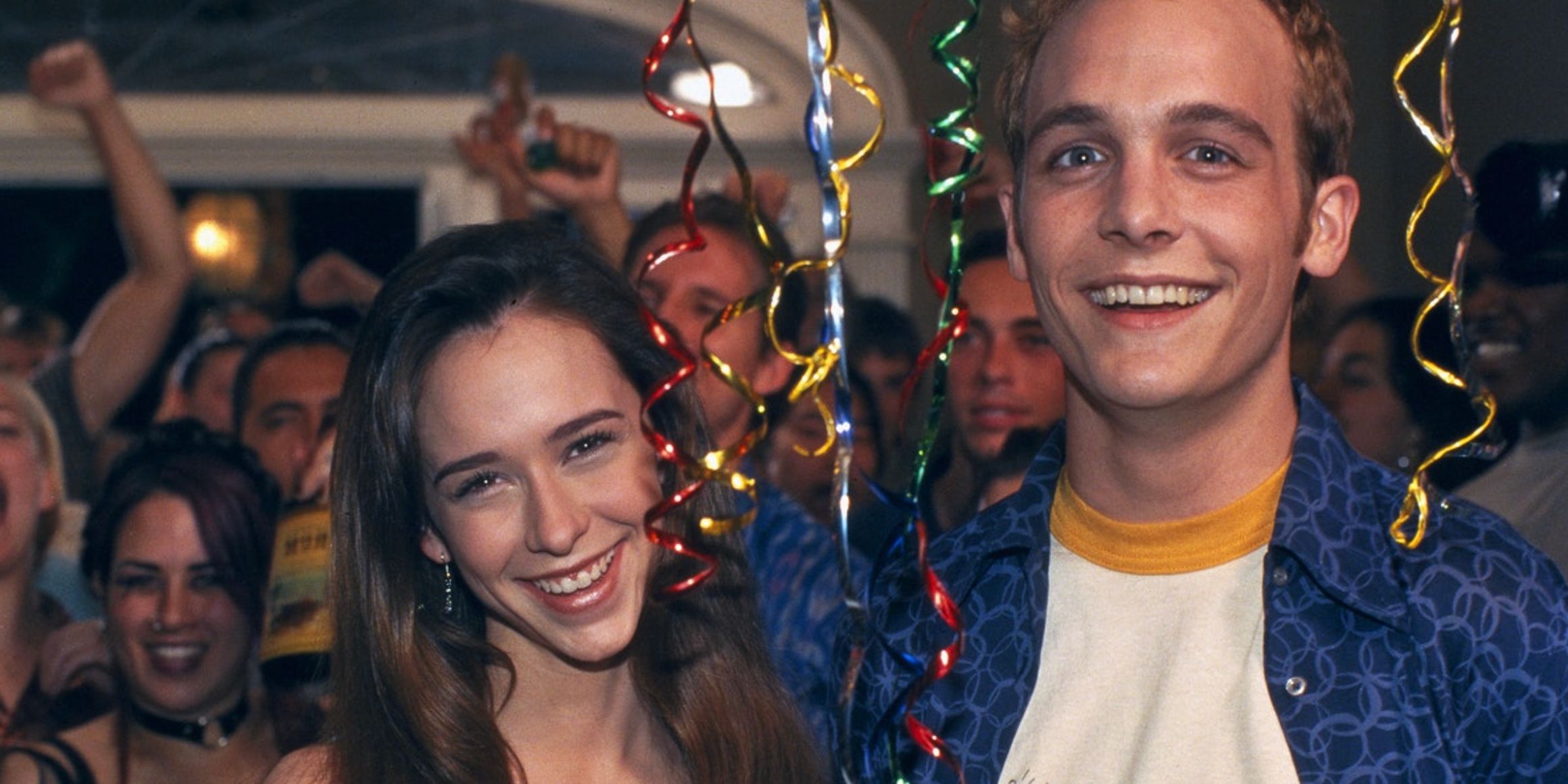 Amanda and Preston smile in the midst of a party in Can&rsquo;t Hardly Wait