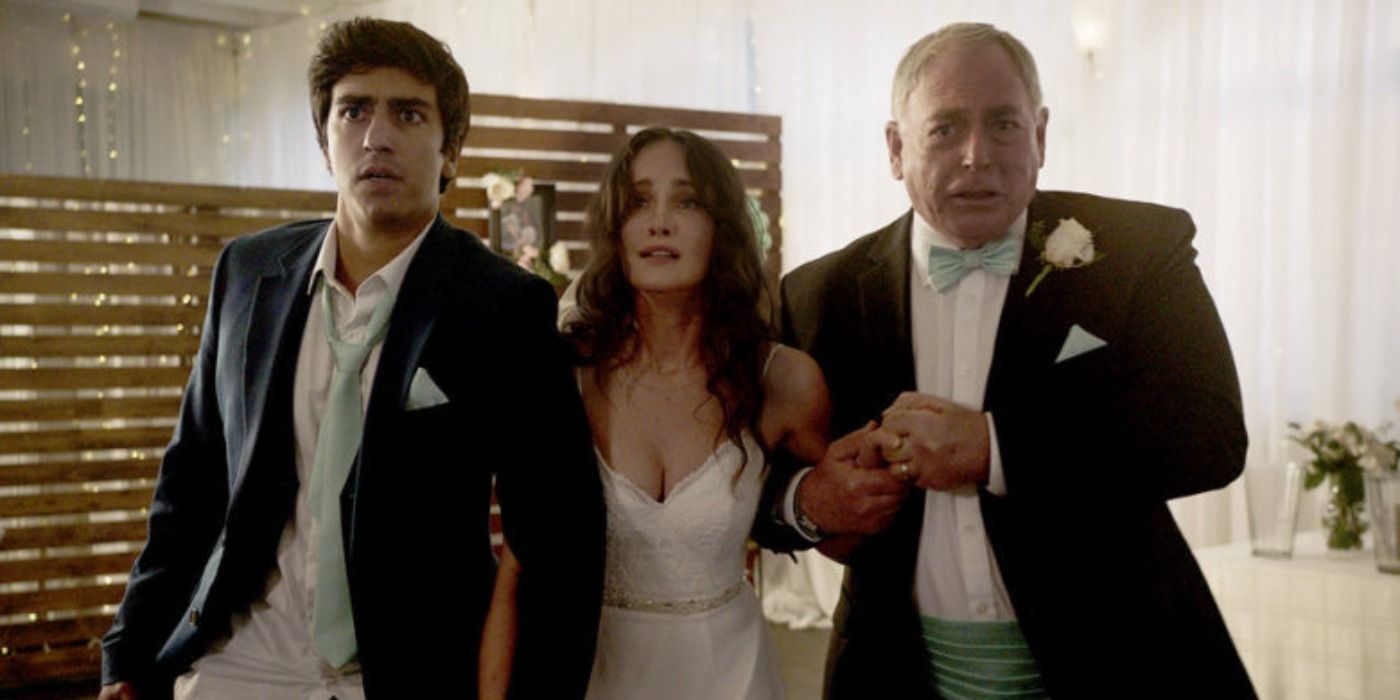 Amy in wedding dress grasps two men&rsquo;s arms in terror in Day of the Dead