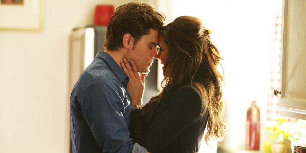 Elena and Stefan hugging in the kitchen in The Vampire Diaries