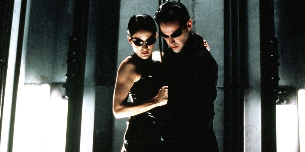 Neo and Trinity standing on a lift in The Matrix