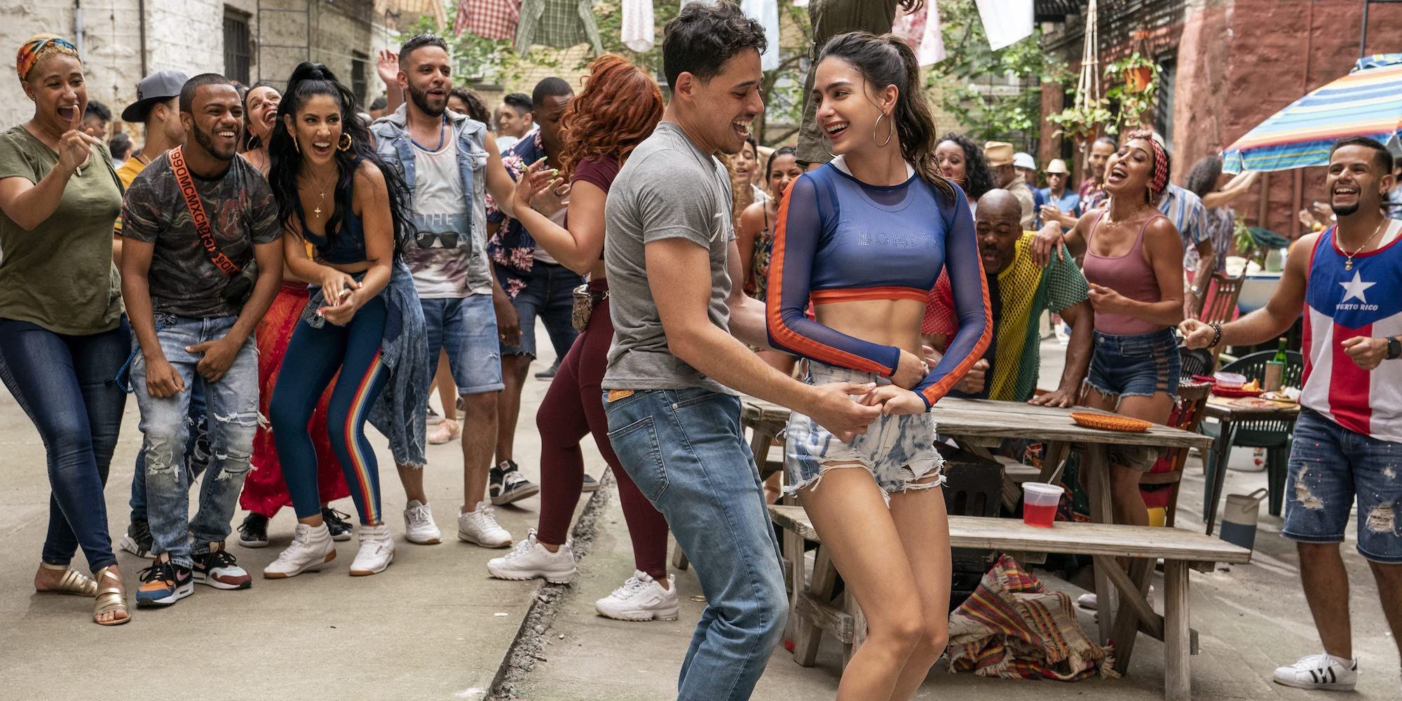 Usnavi and Vanessa dance in front of a crowd In the Heights