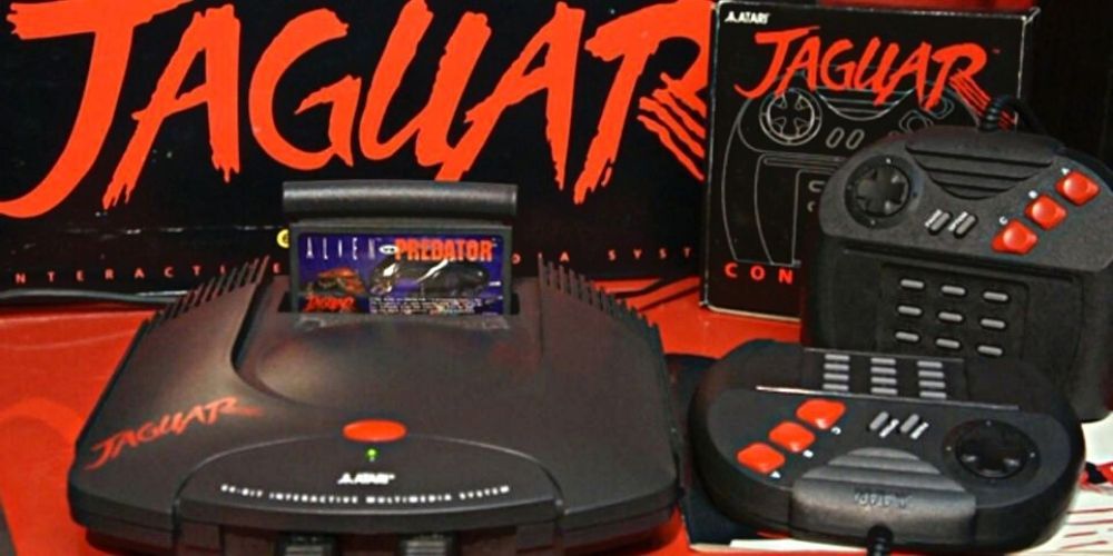 An Atari Jaguar sits in front of its box next to two controllers