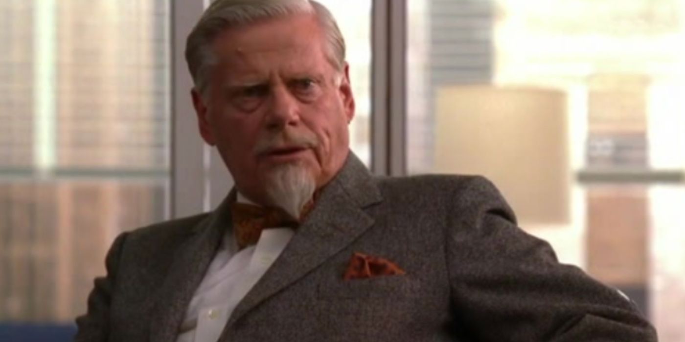 Bertram Cooper sitting in his office in a suit on Mad Men