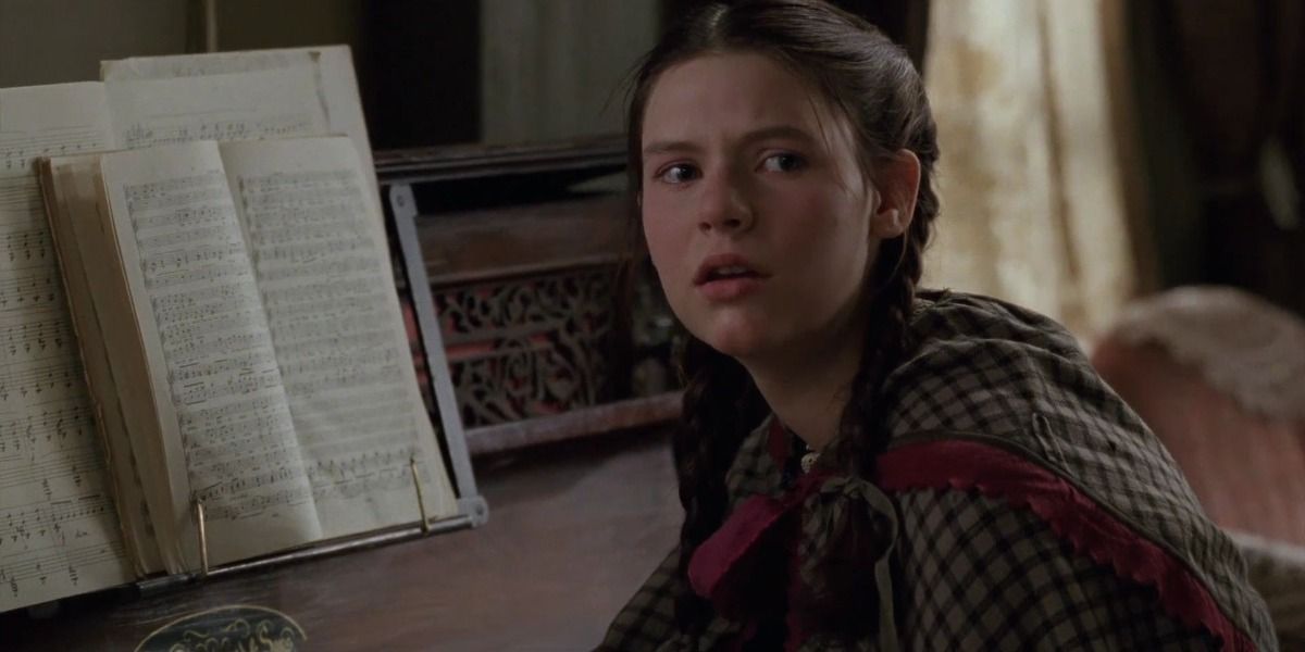 Screencap of Beth in a plaid cape in Little Women