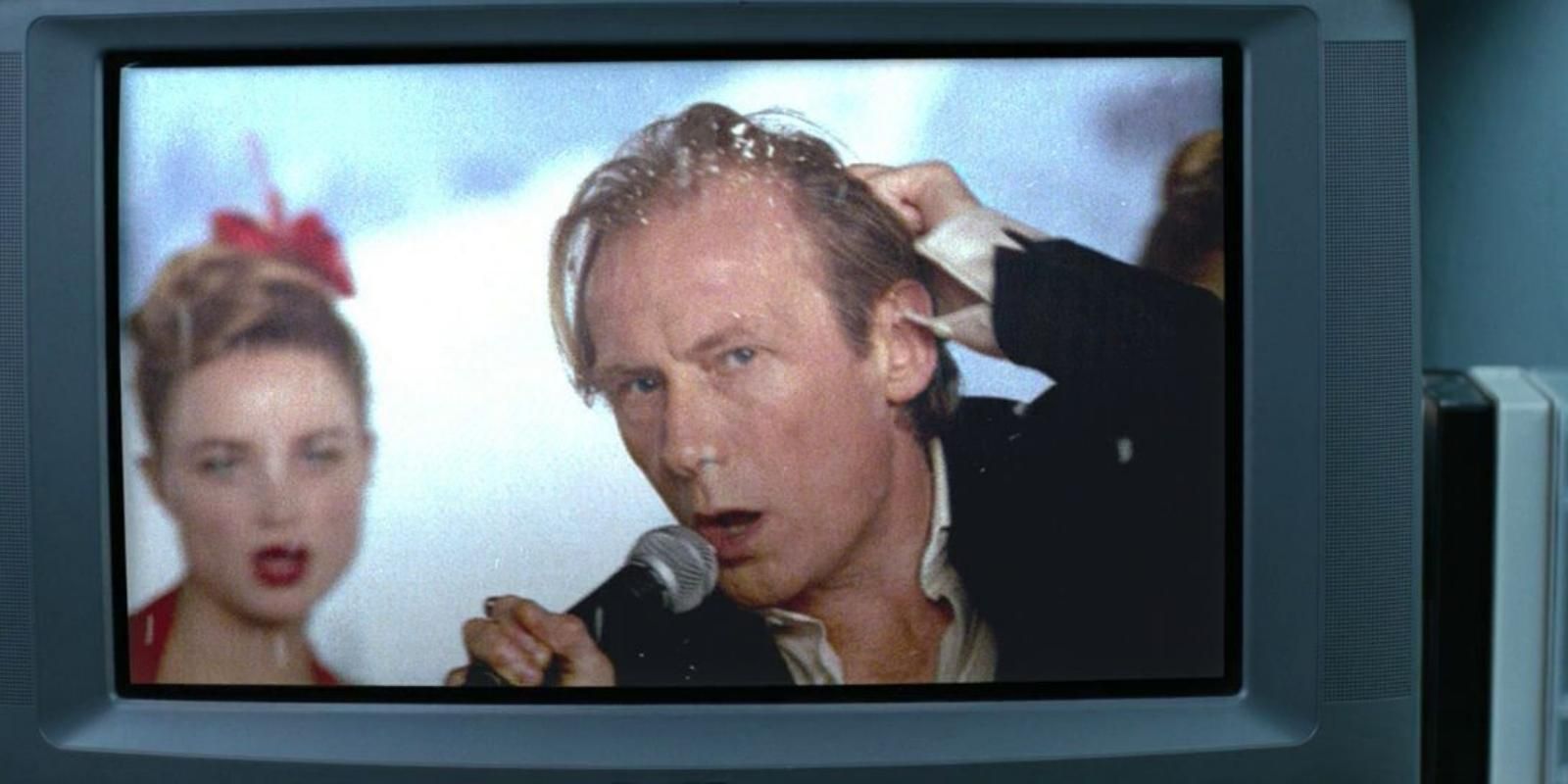 Billy Mack stares into the camera on a television screen in Love Actually