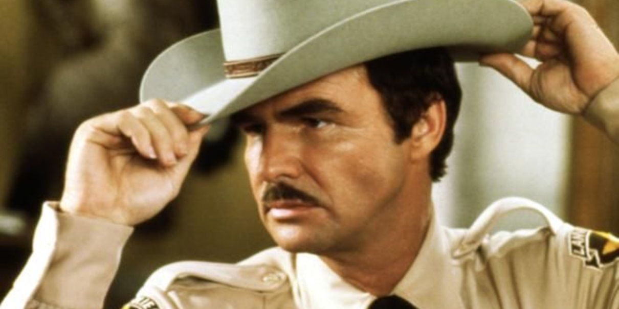 Burt Reynolds adjusting his hat at the Best Little Warehouse in Texas