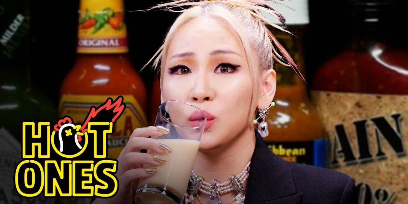 CL drinks a glass of milk on the web series Hot Ones