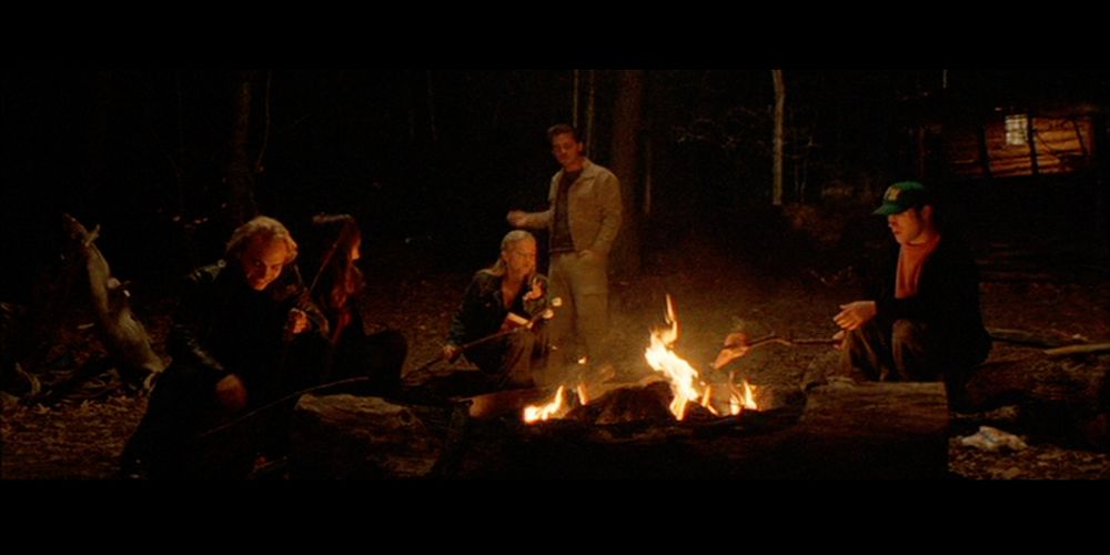 The main group of protagonists around a fire in the 2002 movie Cabin Fever.