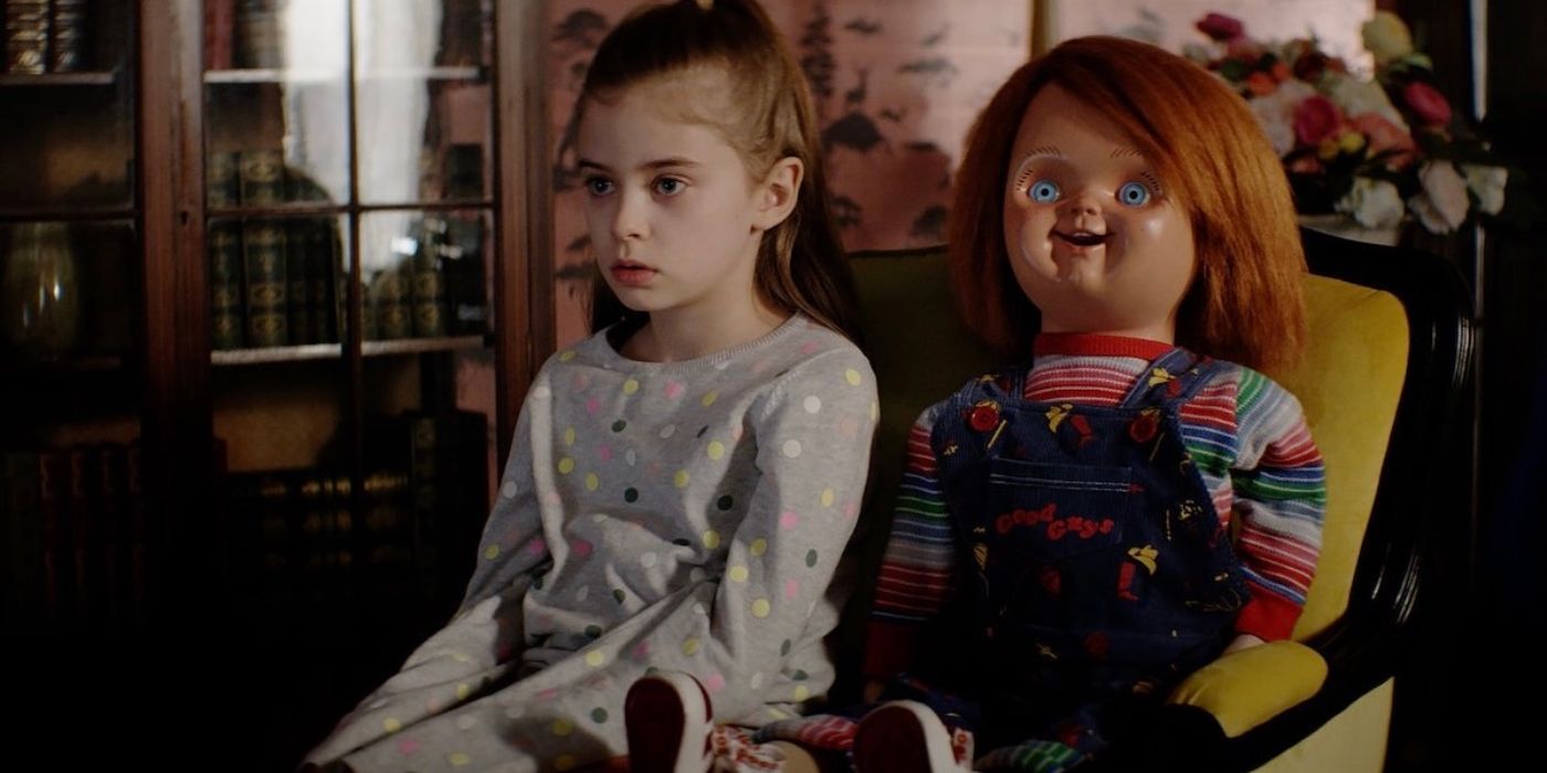 Caroline sitting down with Chucky the doll on Chucky