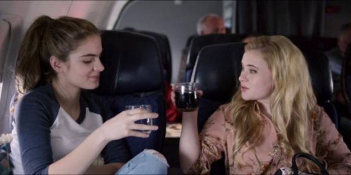Main characters in Christmas In The Heartland (2017) drinking wine on the plane