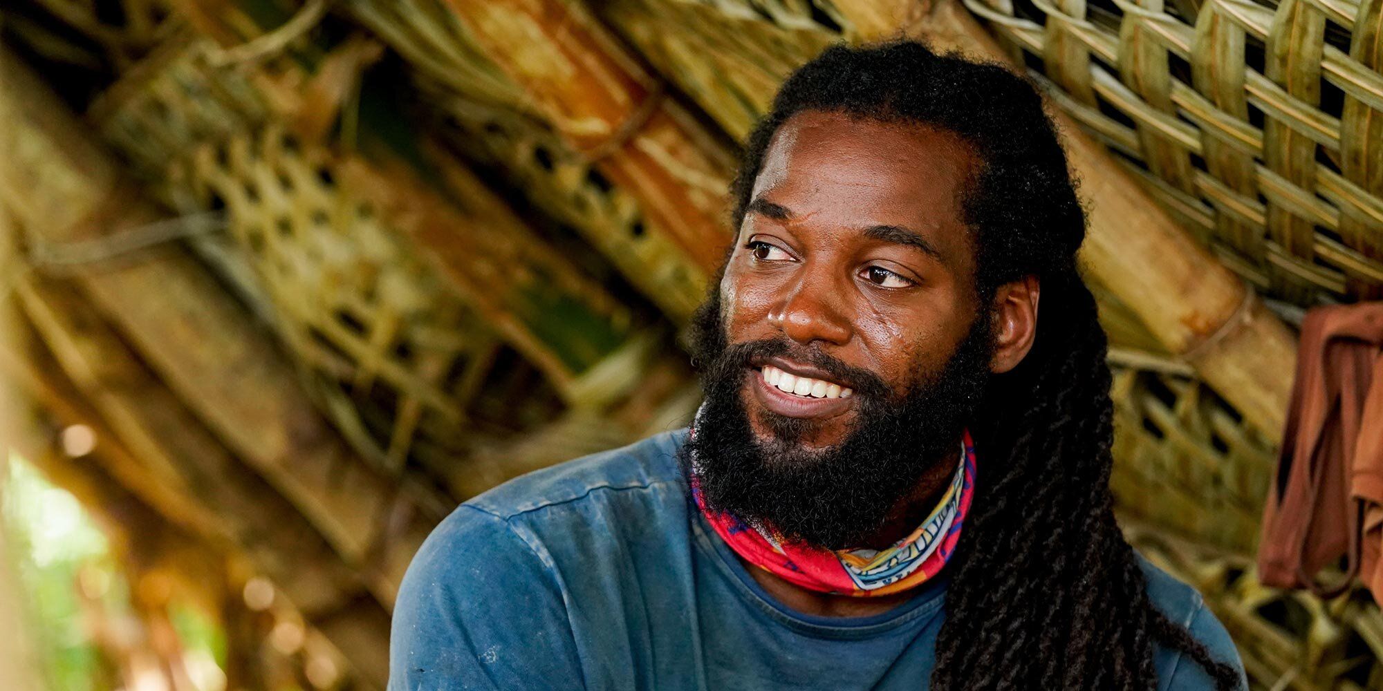 Danny McCray in Survivor 41 smiling with blue t-shirt and red buff on