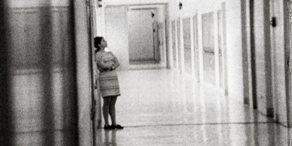 A woman leans against the wall from the documentary High School
