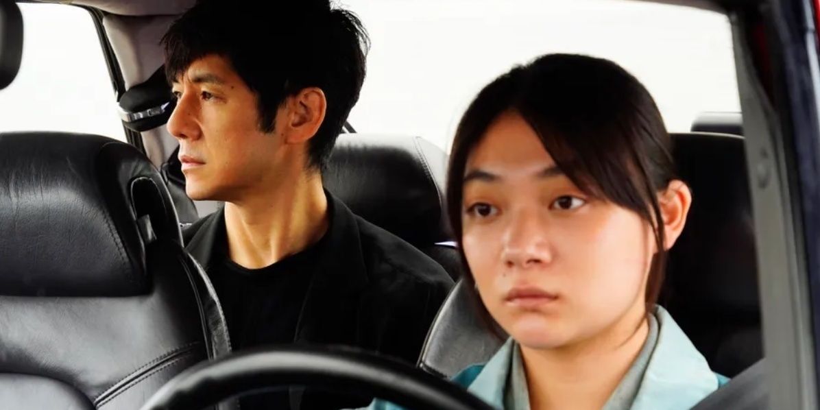 Misaki drives while Yusuke sits in the back in Drive My Car