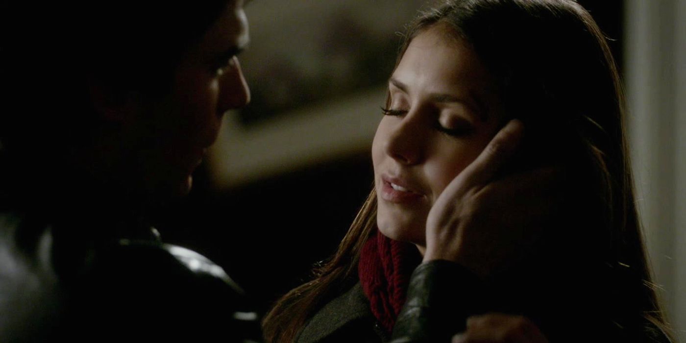 Elena closes her eyes and stops Damon from holding her face
