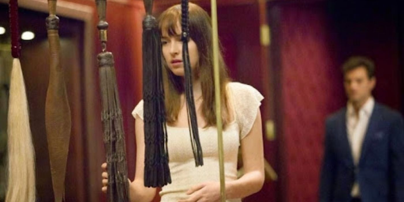 Ana exploring the whips in Christian's red room in Fifty Sahdes of Grey