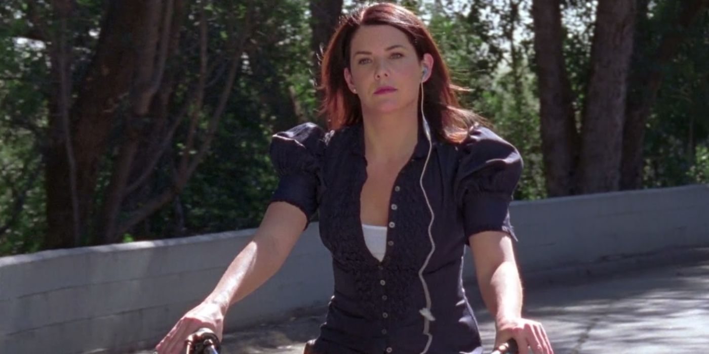 Lorelai riding a bike outside on Gilmore Girls