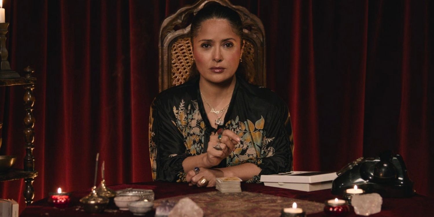 Giuseppina sits at a table surrounded by candles in House of Gucci