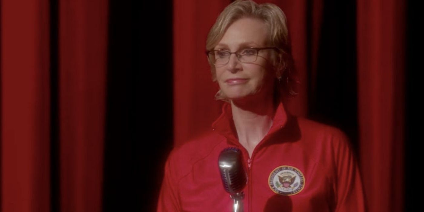 Sue talking into a microphone in Glee