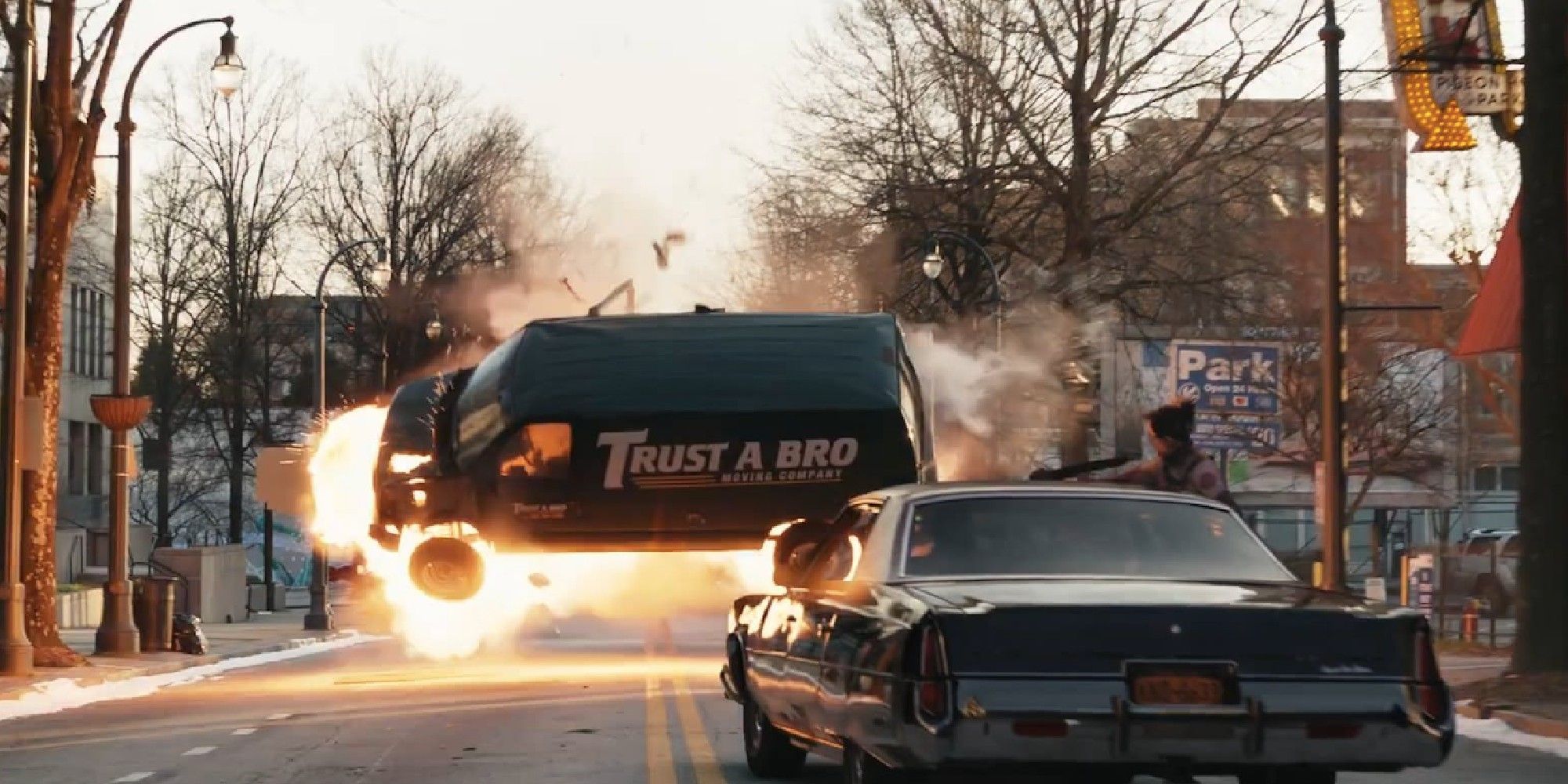 The Tracksuit Mafia's van is blown into the air by an explosion as Kate watches from a car in Hawkeye.