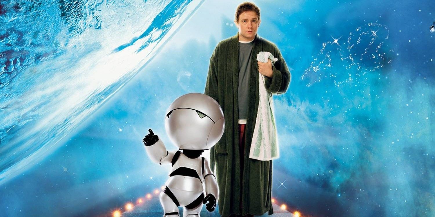 A man holding a towel stands next to a sad robot from Hitchhiker's Guide to the Galaxy