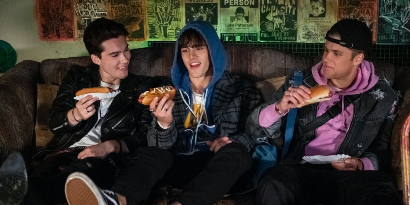 Reggie, Luke, and Alex toast their hotdogs while there is a missing person poster behind Luke in Julie And The Phantoms