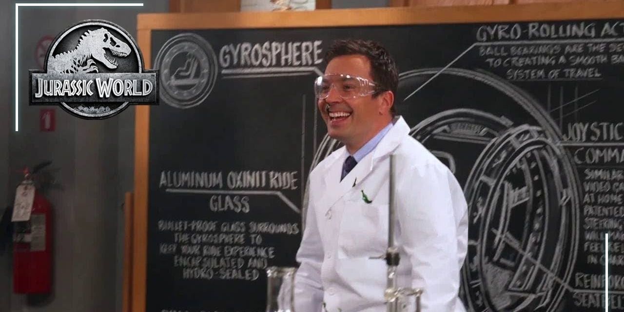 Jimmy Fallon wearing a labcoat and smiling in a still from Jurassic World 