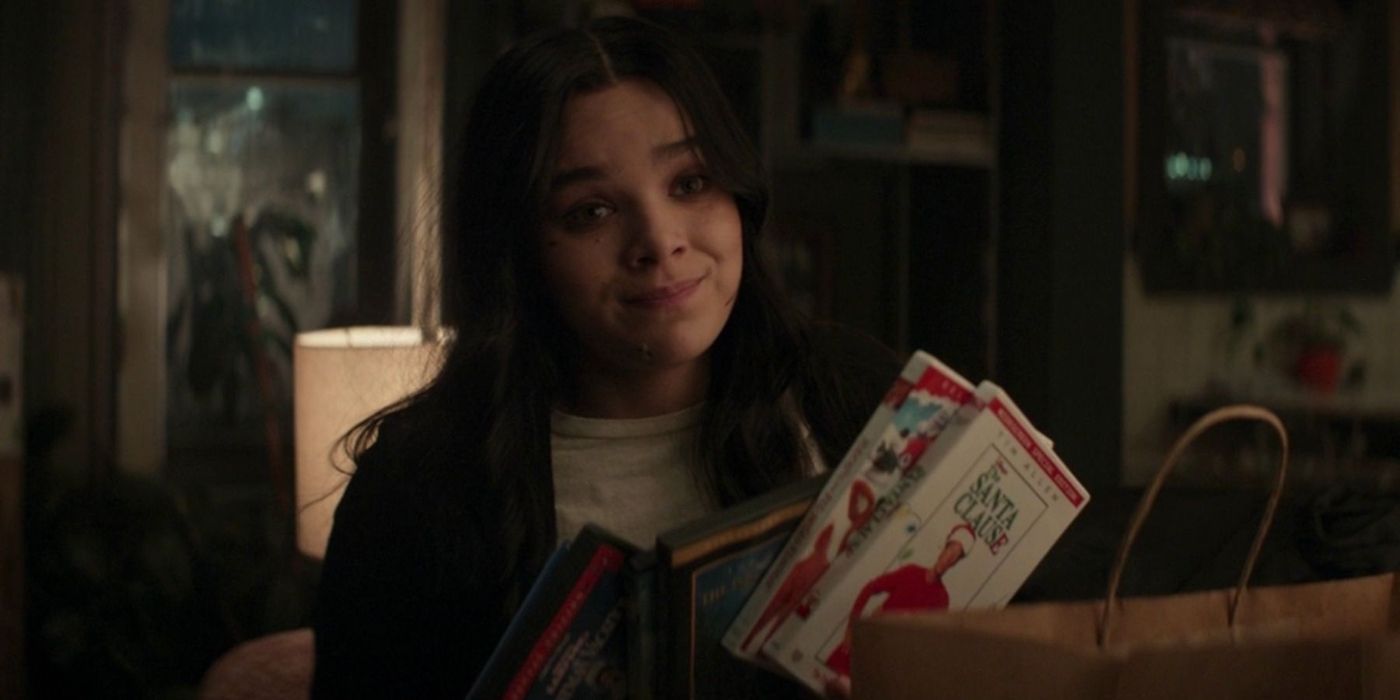 Kate holding Christmas movies in Hawkeye.